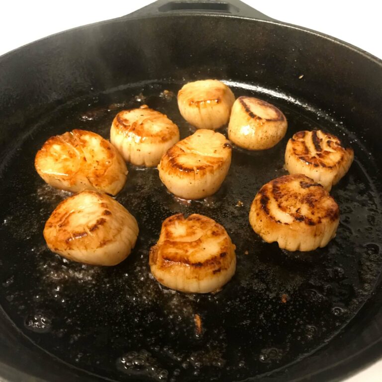 scallops cooking in skillet.