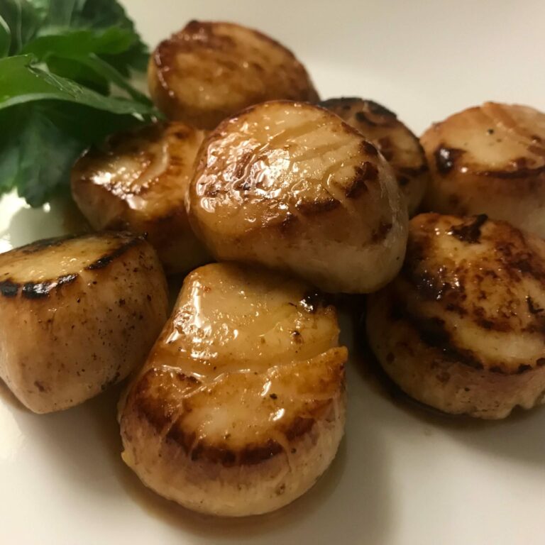 cooked scallops on a plate.
