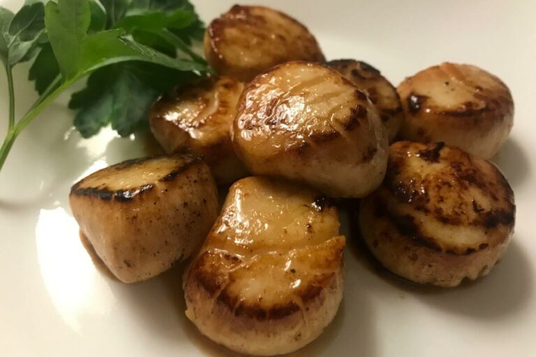 cooked scallops on a plate.