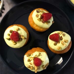Vanilla Cupcakes with Raspberry Filling and Pistachio Whipped Cream