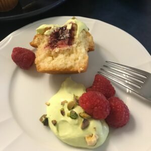 Vanilla Cupcakes with Raspberry Filling and Pistachio Whipped Cream