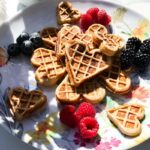plate of heart-shaped vanilla protein waffles.