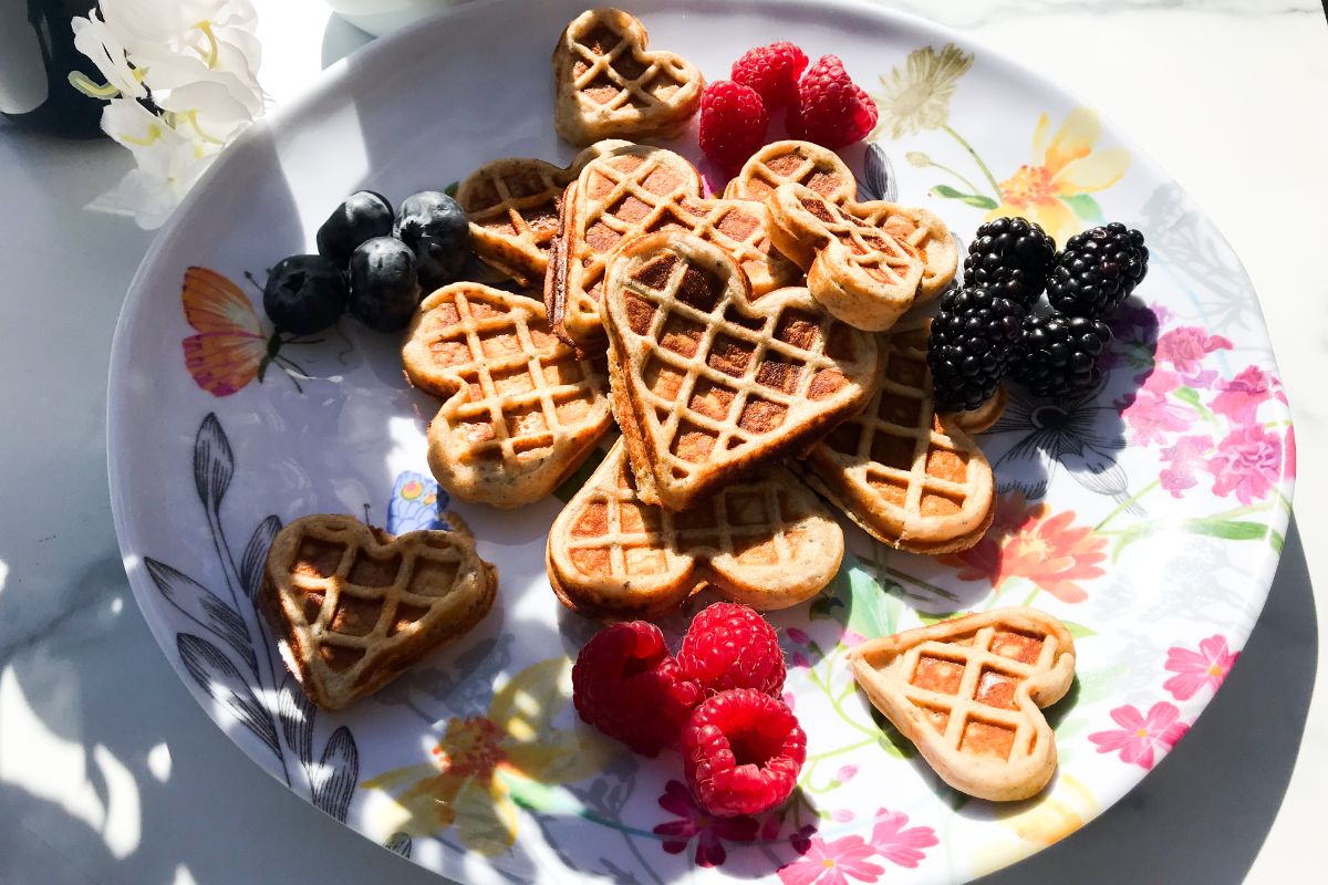 plate of heart-shaped vanilla protein waffles.