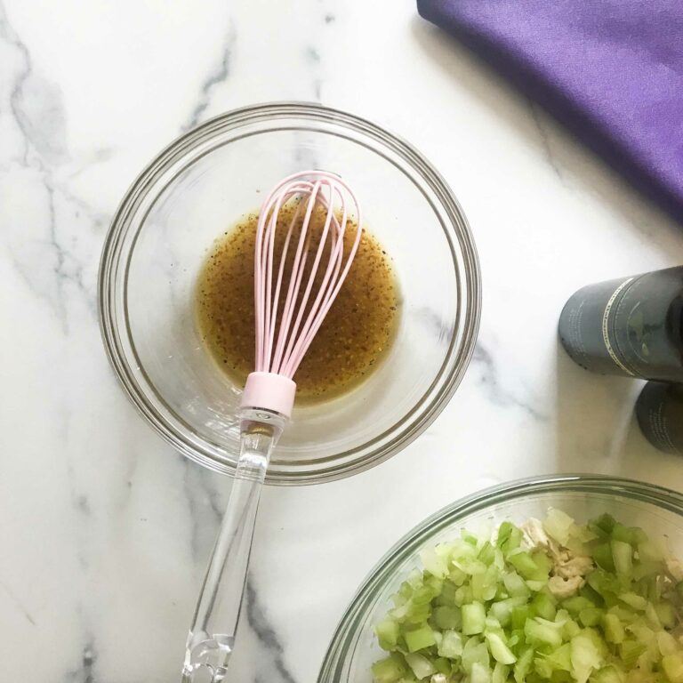 dressing in bowl with whisk.