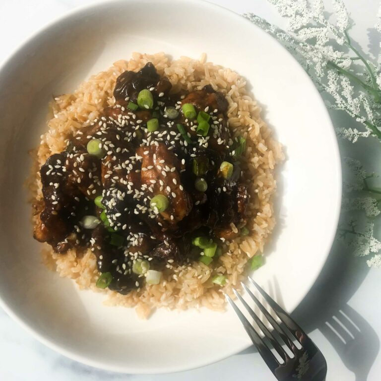 a bowl of healthy bourbon chicken over brown rice.