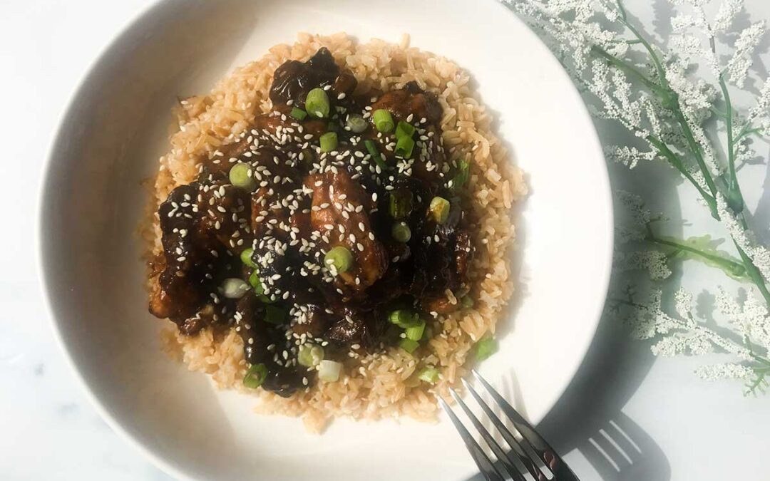 bowl of healthy bourbon chicken on brown rice.