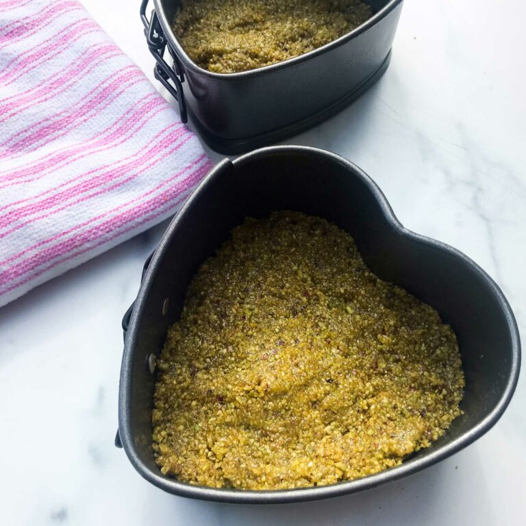 pistachio crust pressed in cake pans.