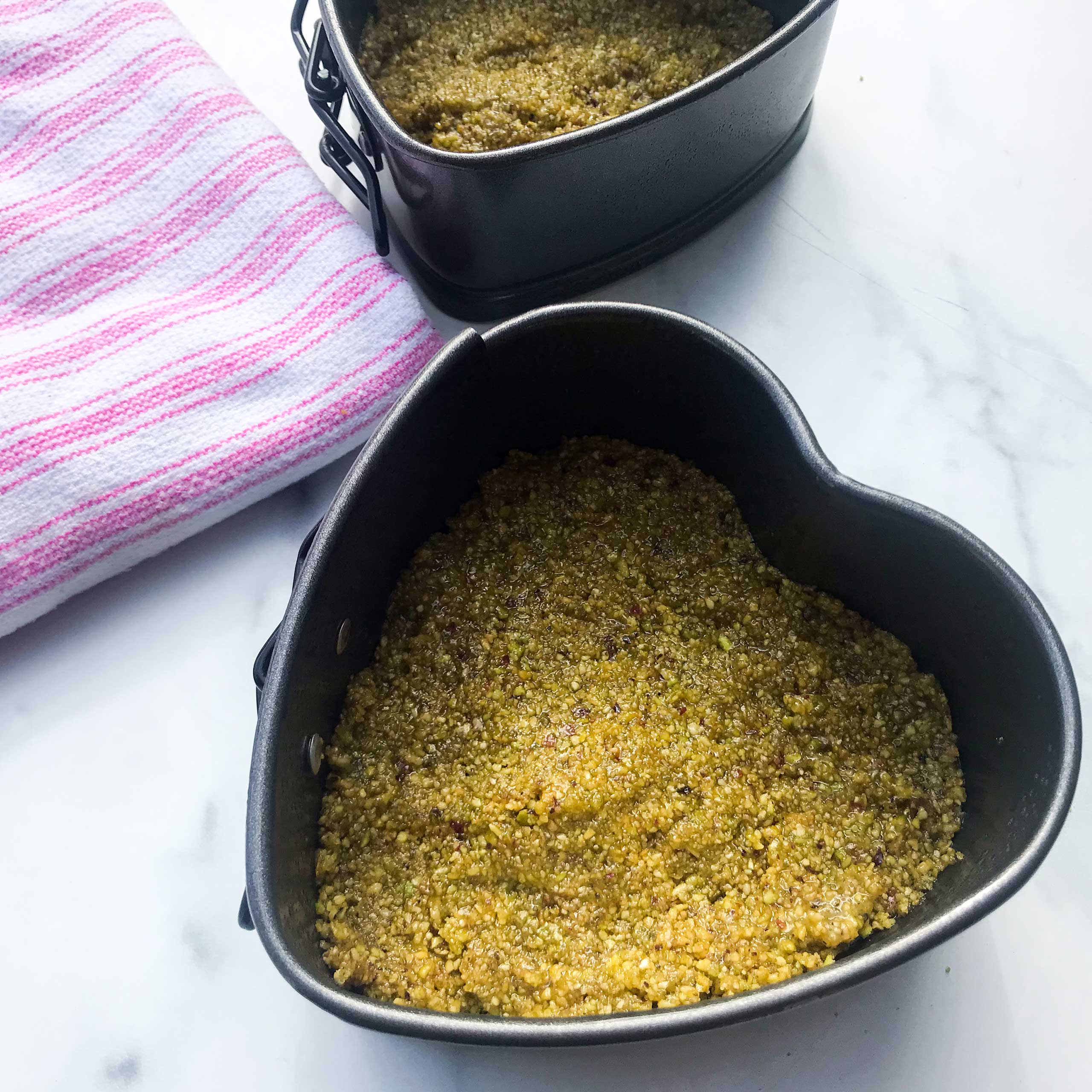 pistachio crust pressed into pans.