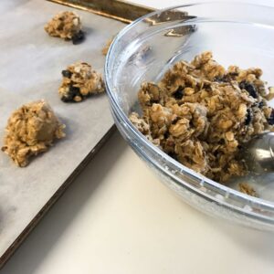 bowl of cookie dough and tray of raw cookies.