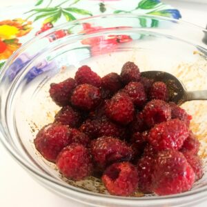 raspberries macerating in a bowl.