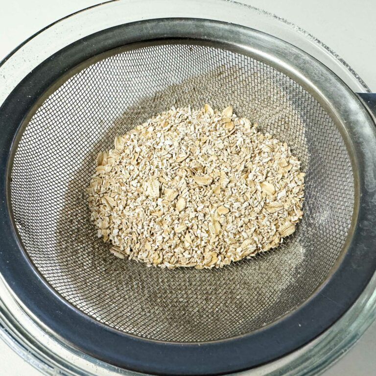 oat flour being put through sieve.
