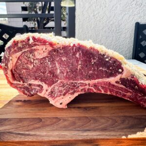 Raw rib roast covered in garlic and shallot crust.