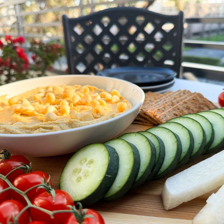 hummus and dippers on a serving board.