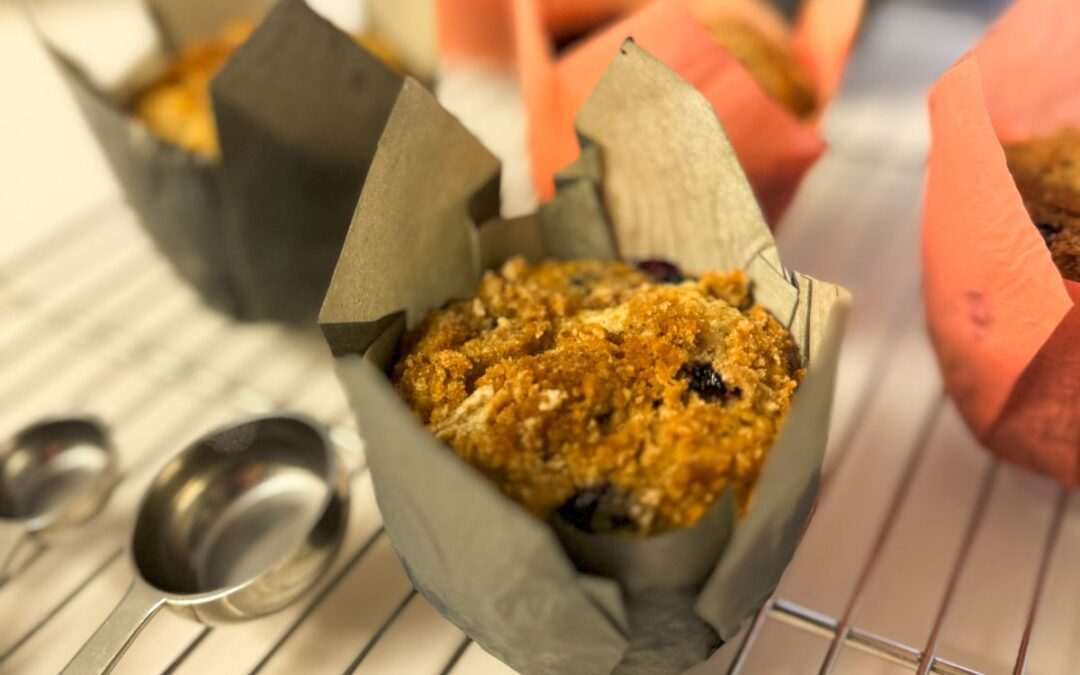 blueberry streusel muffins on a rack.