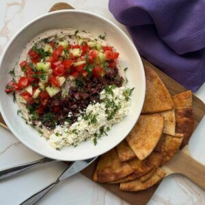 Greek Five Layer Dip with pita chips.
