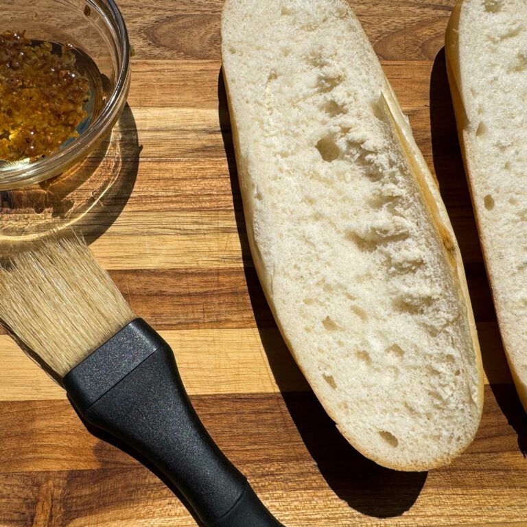 bread, basting brush and dish of garlic oil.