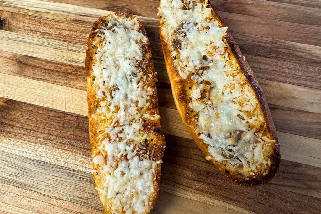 roasted garlic parmesan bread on a cutting board.