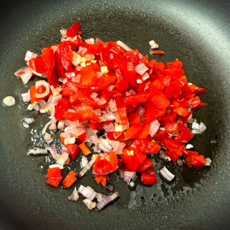 bell pepper and shallots cooking in skillet.