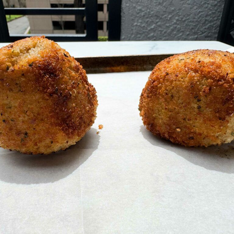 fried meatballs on baking sheet.