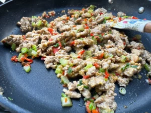 mushroom filling cooking in skillet.