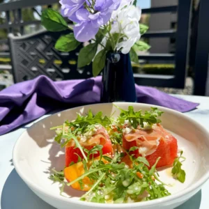 compressed watermelon salad on a plate.