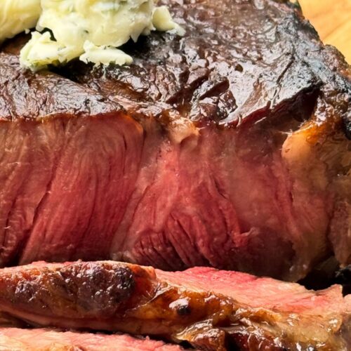 cooked and sliced ribsteak with herb butter.