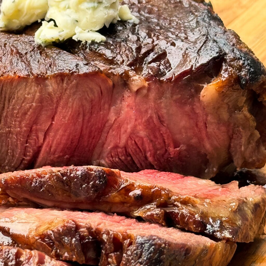 sliced steak with herb butter.