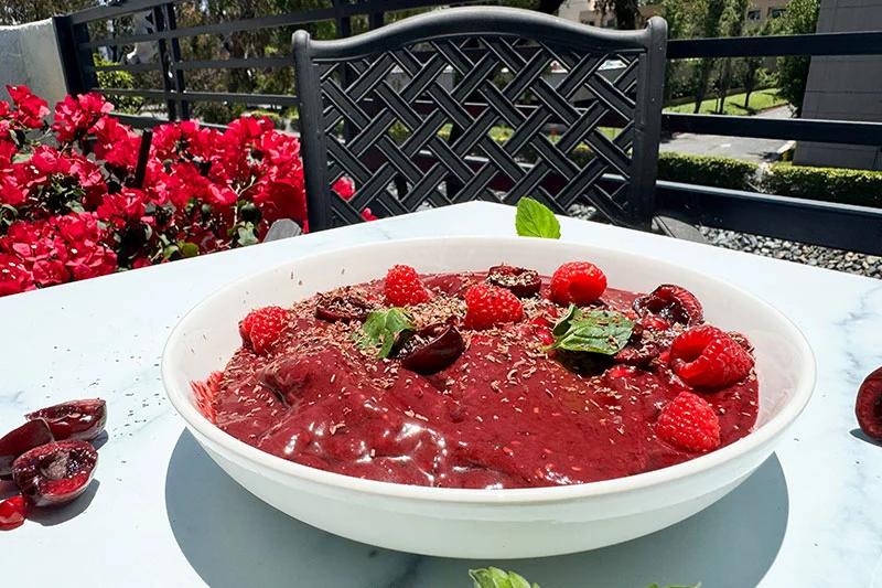 cherry, acai, pomegranate & raspberry smoothie bowl with all the toppings.