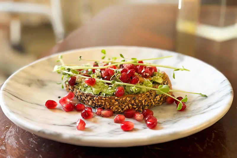 everything bagel avocado toast with pomegranate.