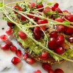 everything bagel avocado toast with pomegranate.