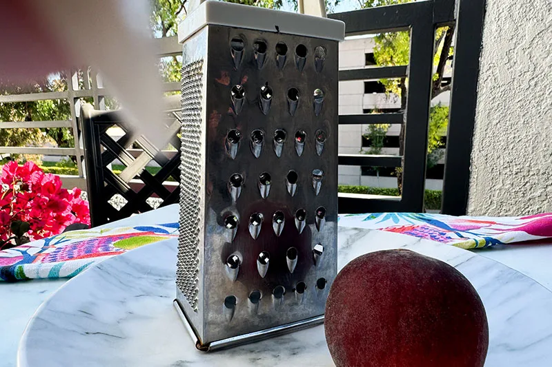 frozen peach and box grater.