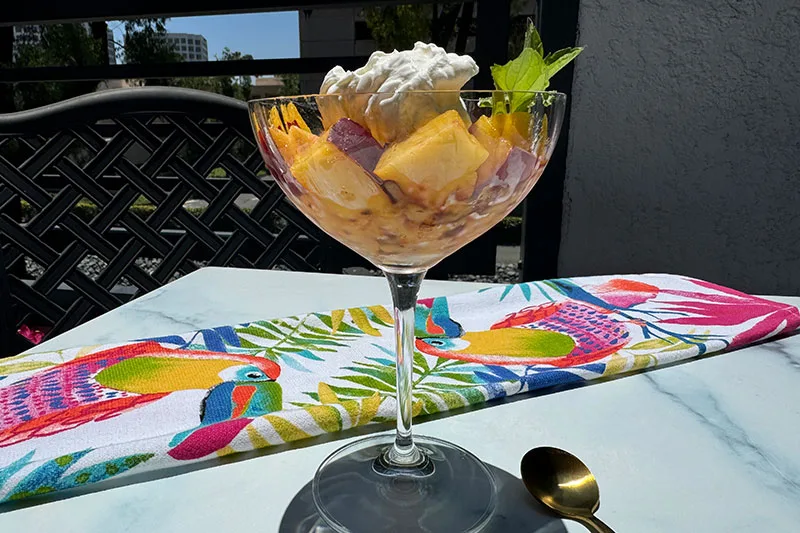 grated frozen peaches and cream in a coup glass.