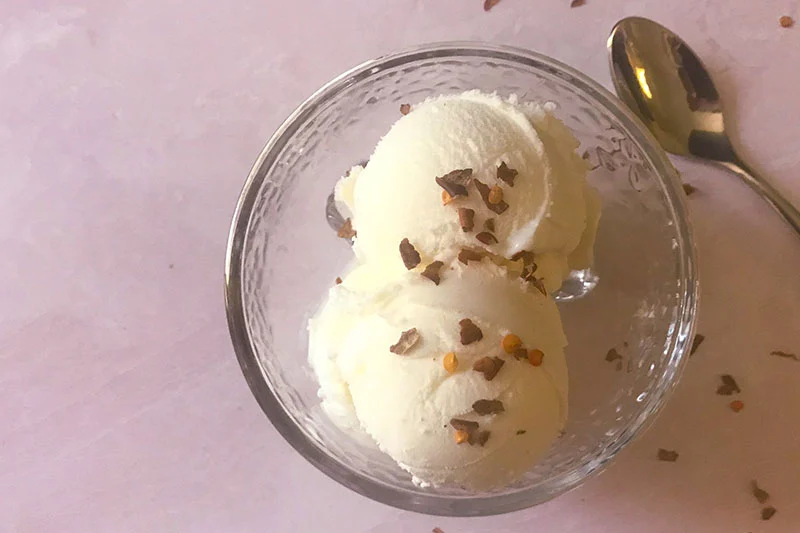 a bowl of ice cream with chili flakes on top.