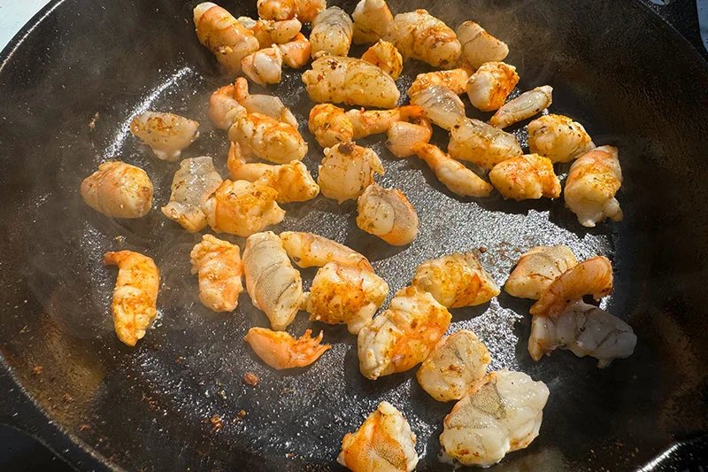 shrimp cooking in skillet.