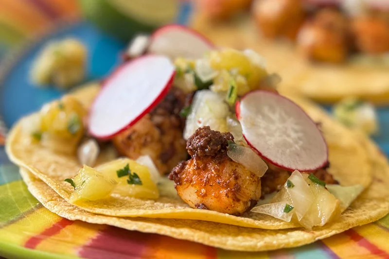 shrimp and chorizo tacos with toppings.