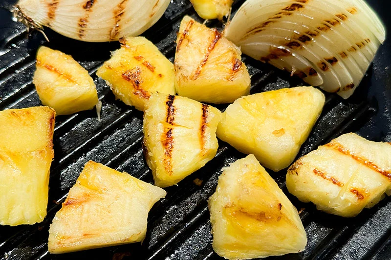 pineapple and onion on grill pan.