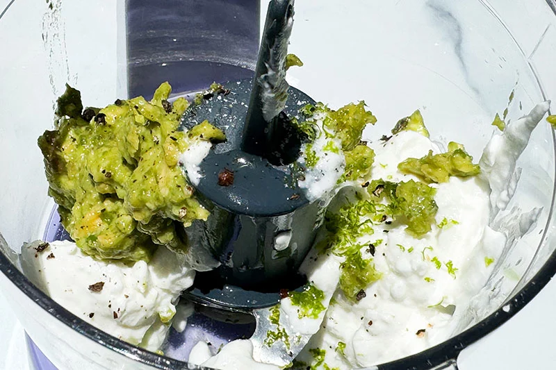 ingredients for avocado crema in food processor.