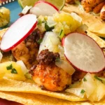 shrimp and chorizo tacos with toppings.