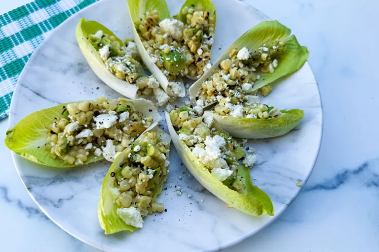 Belgian endive salad cups on a plate.