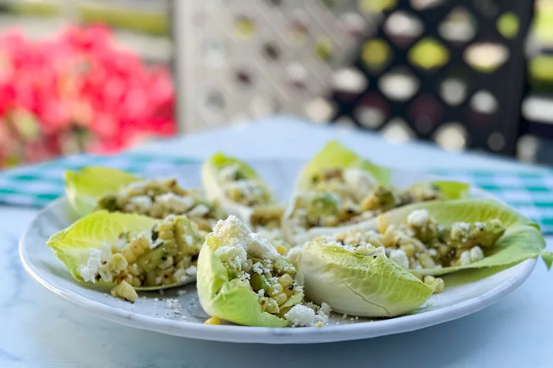 Belgian endive salad cups on a plate.