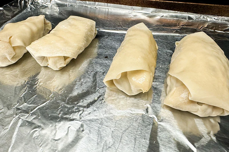 spring rolls on a baking sheet.