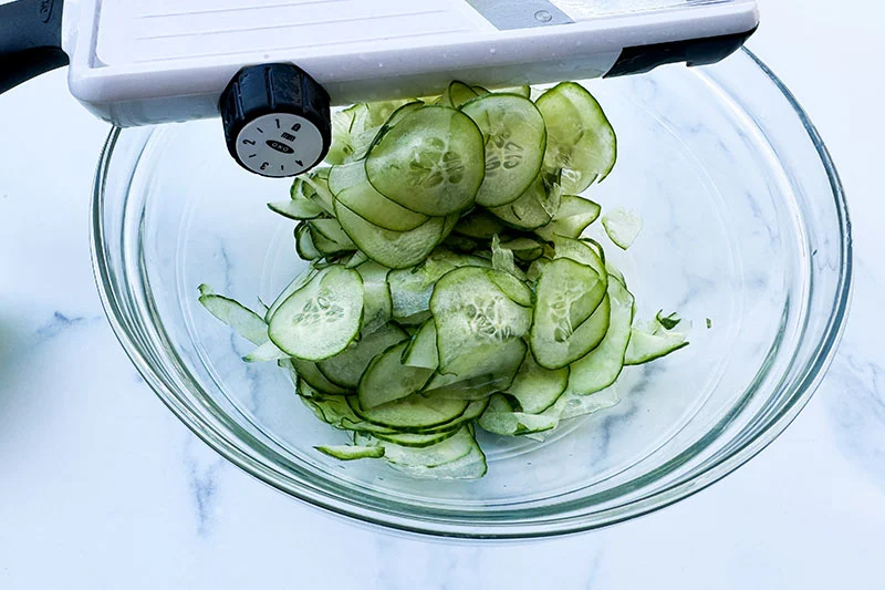 sliced cucumbers in a bowl.