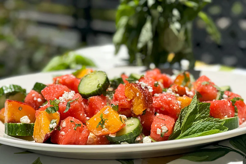 a platter of watermelon, peach, feta salad.