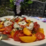 Platter of heirloom tomatoes, peaches and burrata.