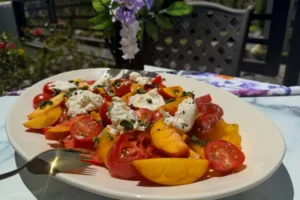 Platter of heirloom tomatoes, peaches and burrata.