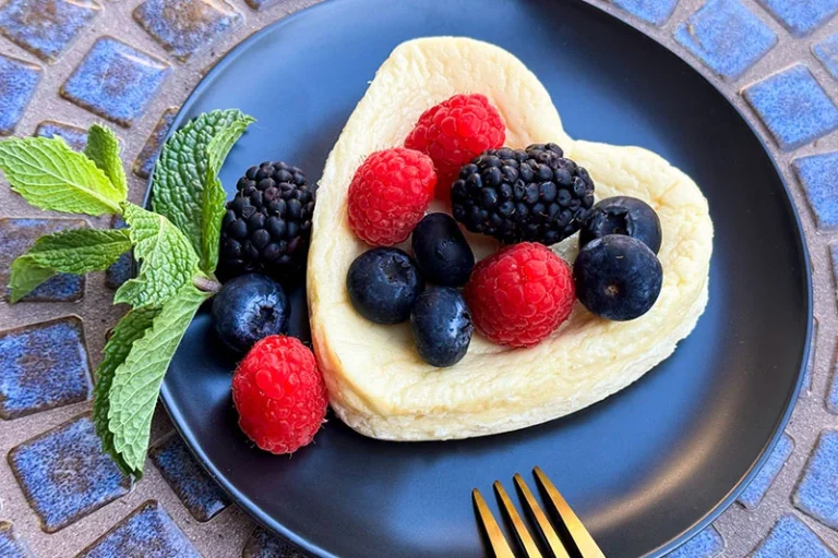 cottage cheese cake topped with berries an mint.