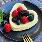 cottage cheese cake topped with berries an mint.