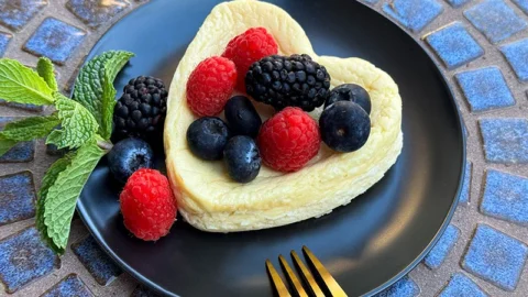 cottage cheese cake topped with berries an mint.