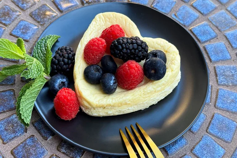 cottage cheese cake topped with berries an mint.