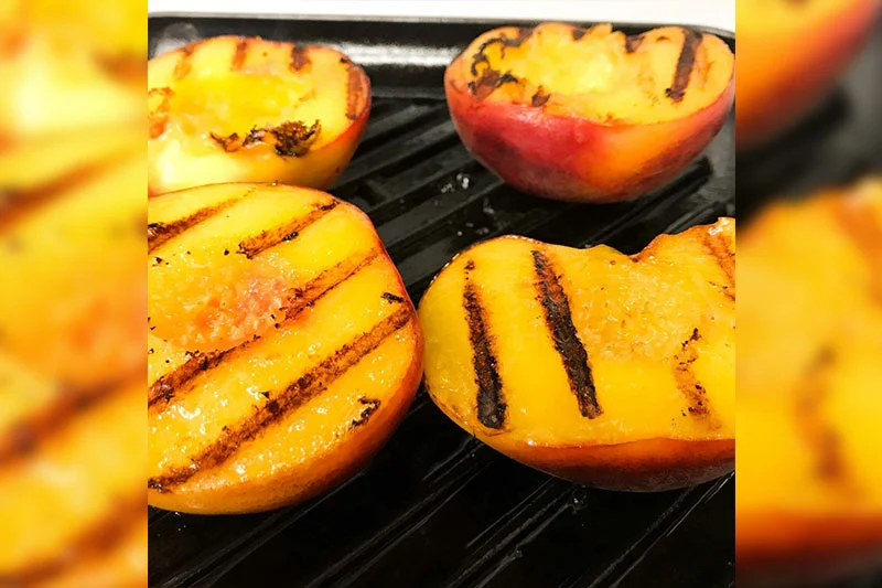 peaches grilling on grill pan.